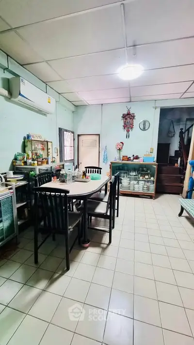 Charming kitchen with dining area, featuring vintage decor and ample natural light, perfect for cozy family meals.