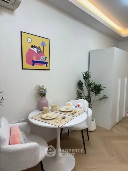 Cozy dining nook with modern decor and charming artwork