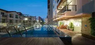 Luxurious residential building with elegant poolside view at dusk, perfect for relaxation and leisure.