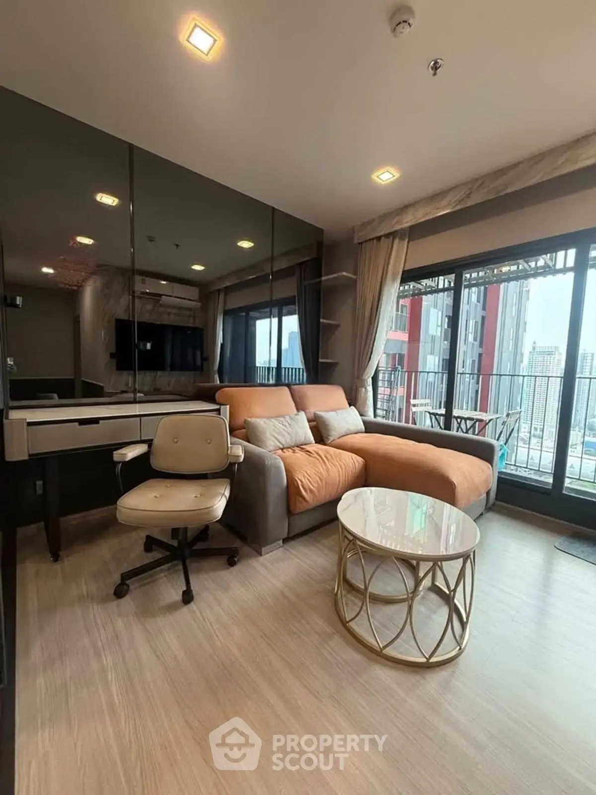 Modern living room with city view, stylish furniture, and large windows.