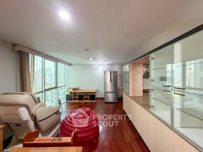 Spacious living room with city view, modern furniture, and open layout in high-rise apartment.