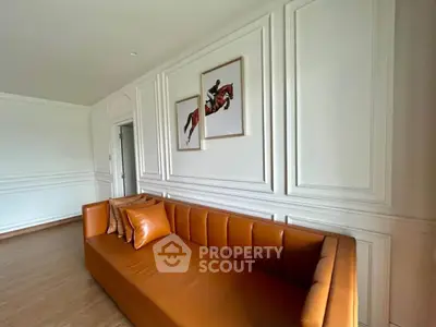 Elegant living room with stylish leather sofa and modern wall art, perfect for contemporary home decor.