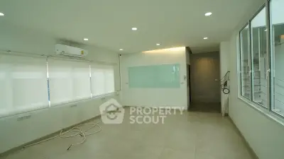 Spacious modern room with large windows and air conditioning, ideal for versatile living space.