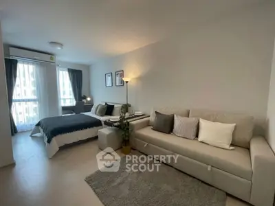 Modern studio apartment with cozy living area and stylish decor