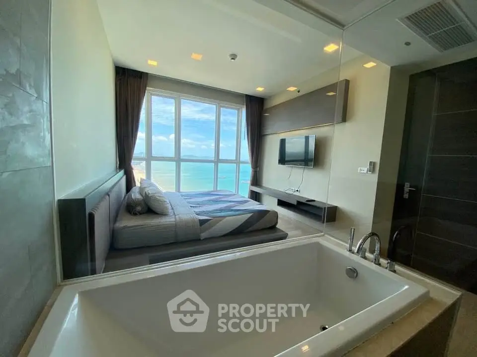Luxurious bedroom with ocean view and modern bathtub, perfect for relaxation and comfort.