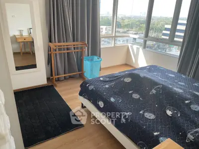 Bright bedroom with large windows and modern decor in urban apartment