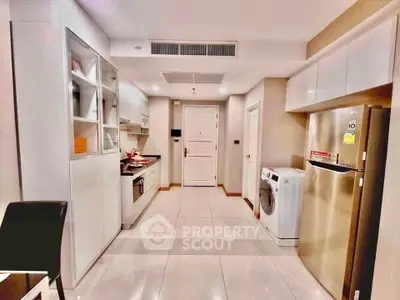 Modern kitchen with sleek appliances and open layout in a stylish apartment.