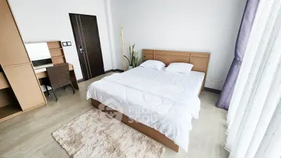 Spacious modern bedroom with elegant decor and natural light