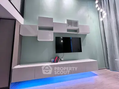Modern living room with sleek wall-mounted TV and stylish storage units.