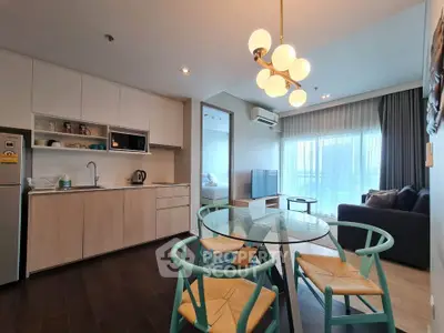 Modern open-plan living room and kitchen with stylish furniture and natural light