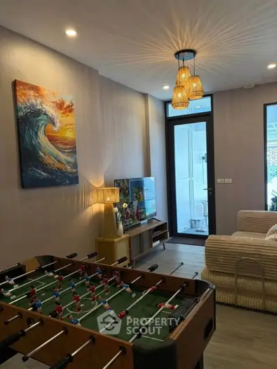 Stylish living room with foosball table and modern decor