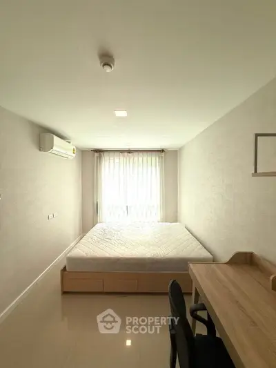 Bright minimalist bedroom with large window and modern furniture