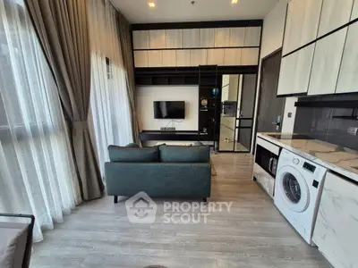 Modern living room with washing machine and sleek design in high-rise apartment