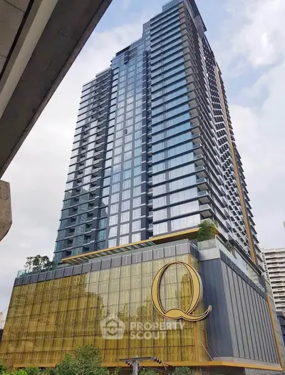Stunning modern high-rise building with sleek glass facade and luxurious design in urban setting.