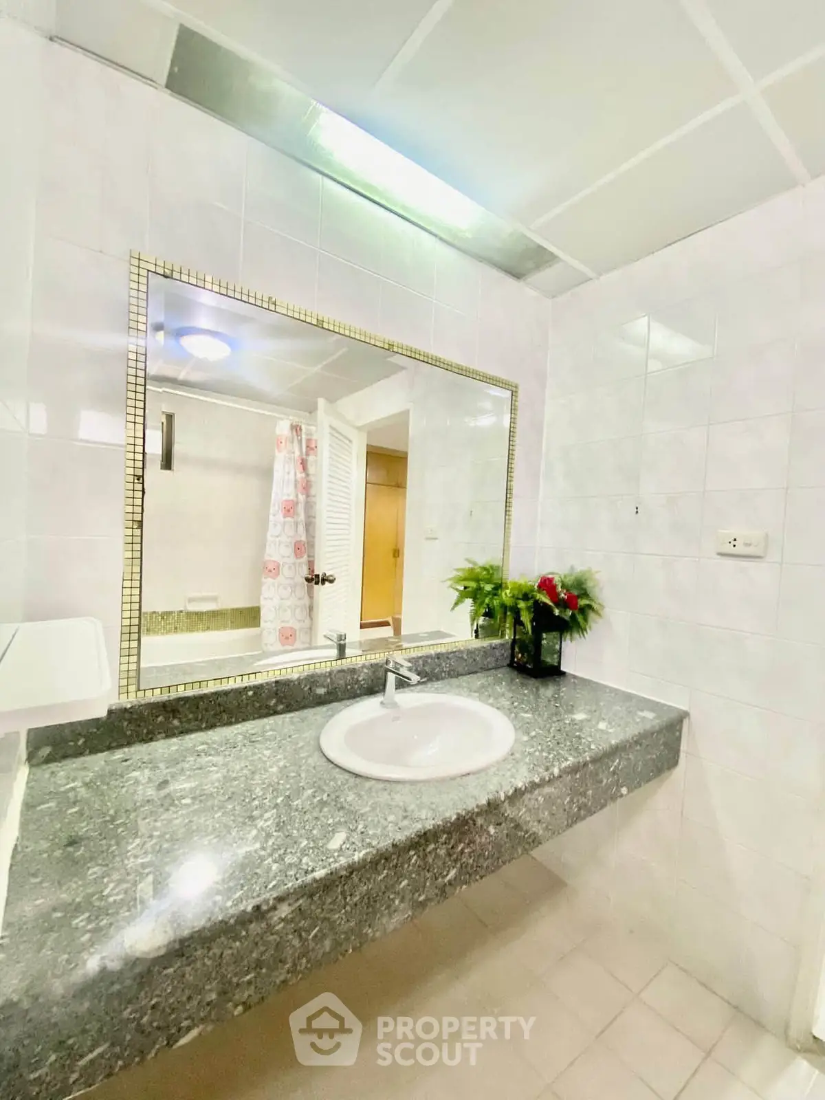 Spacious bathroom with elegant granite countertop and large mirror, perfect for modern living.