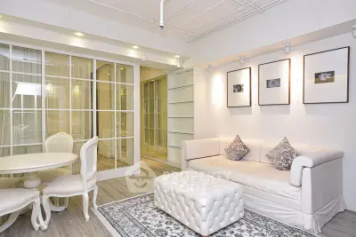 Elegant living room with stylish decor and cozy seating area in modern apartment.
