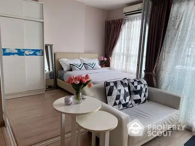 Cozy and inviting studio apartment with a comfortable bed, stylish sofa, and modern decor, perfect for singles or couples seeking a chic urban living space.