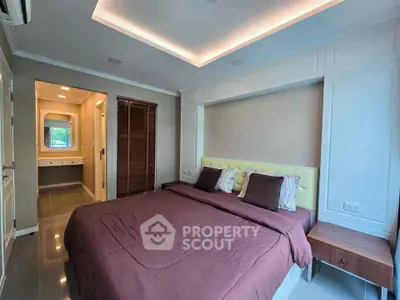 Spacious bedroom with ensuite bathroom in modern apartment
