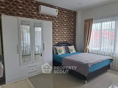 Modern bedroom with stylish decor and ample natural light