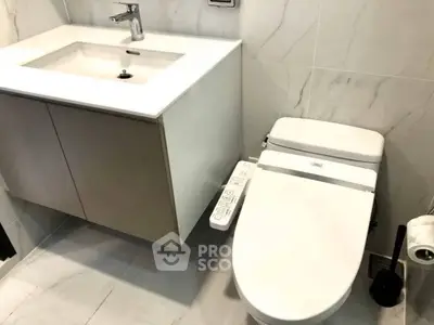 Modern bathroom with sleek fixtures and a smart toilet design.