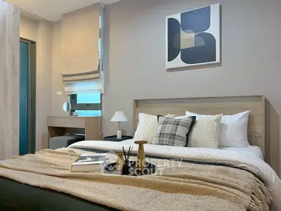 Modern bedroom with stylish decor and cozy ambiance, featuring a comfortable bed and elegant artwork.