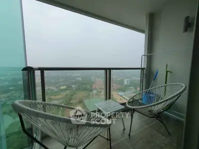 Spacious balcony with stunning panoramic view and modern seating area.