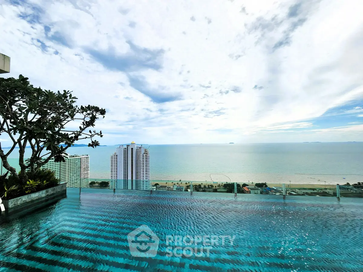 Stunning rooftop infinity pool with panoramic ocean view in luxury high-rise.
