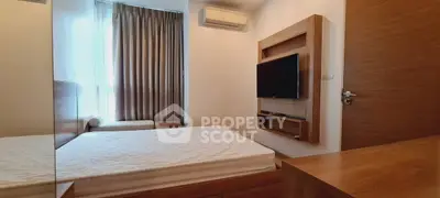 Modern bedroom with wall-mounted TV and air conditioning, featuring sleek wooden furniture and large window.