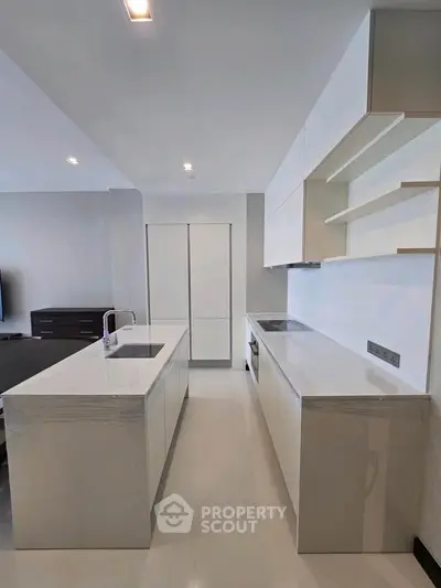 Modern kitchen with sleek white cabinetry and island in open layout