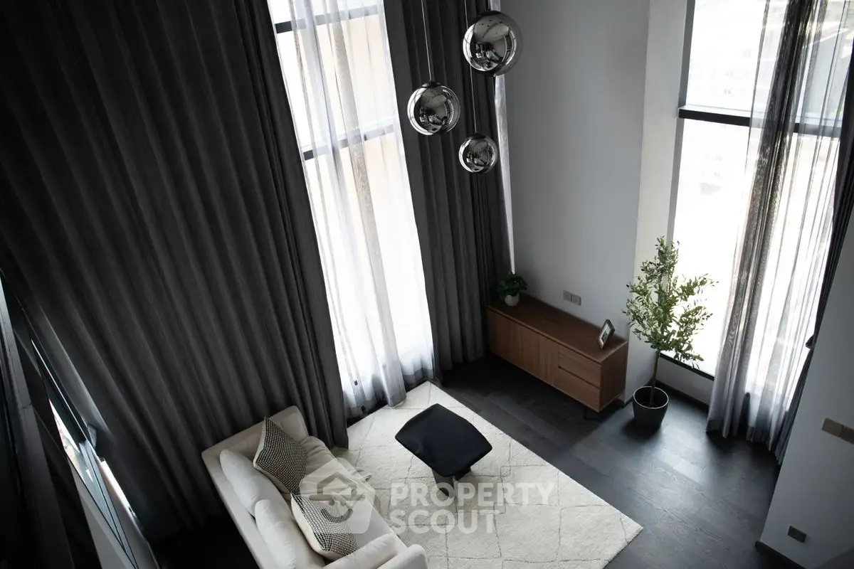 Elegant modern living room with high ceilings and large windows