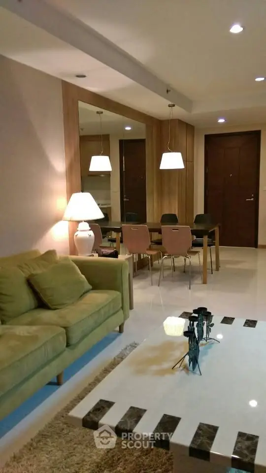 Elegant living room with modern decor and cozy ambiance, featuring stylish furniture and warm lighting.