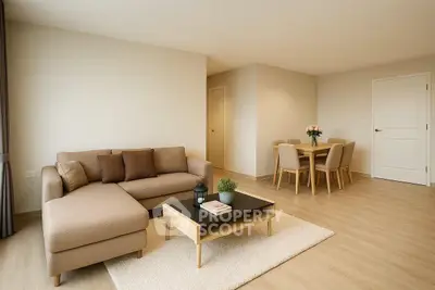 Spacious modern living room with cozy sofa and dining area