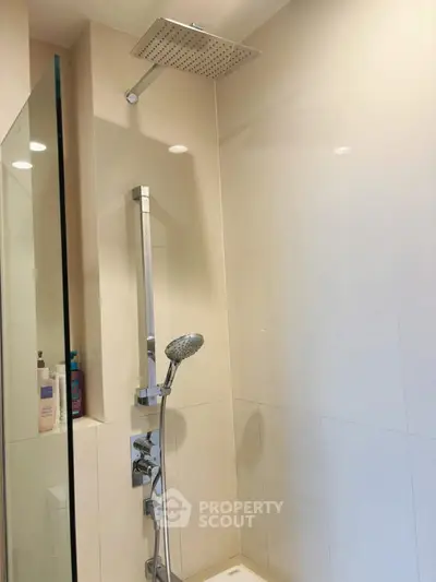 Modern bathroom shower with sleek fixtures and glass partition