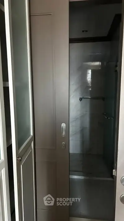 Modern bathroom with sliding door and sleek marble tiles