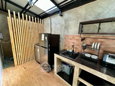 Modern kitchen with sleek appliances and open layout in stylish home