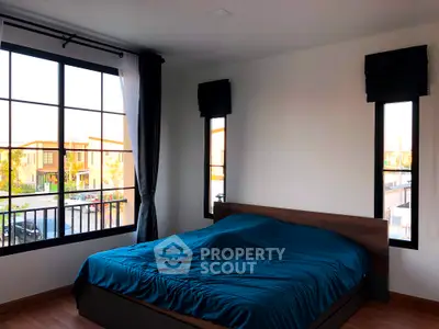 Spacious bedroom with large windows and modern decor in a stylish home