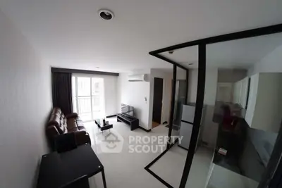 Modern living room with sleek design and open kitchen layout in a stylish apartment.