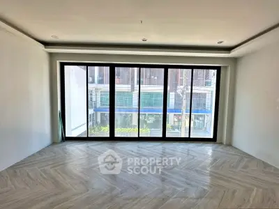 Spacious modern living room with large windows and stylish flooring