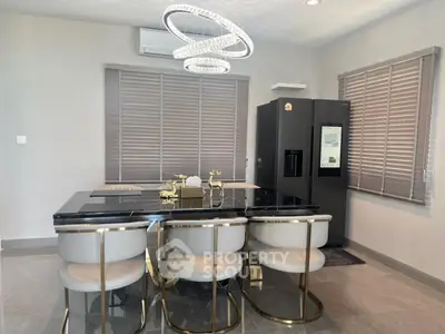 Luxurious modern kitchen with sleek black marble dining table and elegant lighting