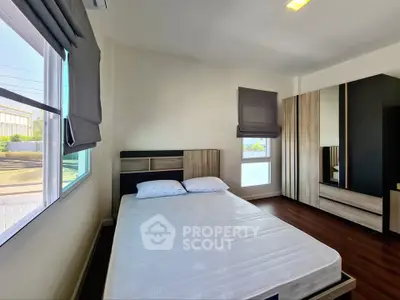 Modern bedroom with stylish decor and ample natural light