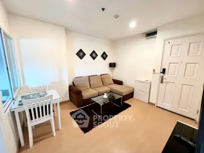 Cozy living room with modern decor, featuring a comfortable sofa and dining area, perfect for relaxation.