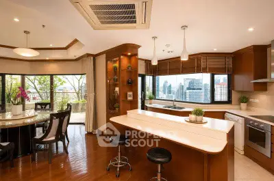 Luxurious open-plan kitchen and dining area with city view and spacious balcony.