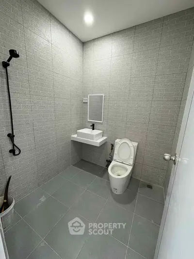 Modern minimalist bathroom with sleek fixtures and neutral tiles