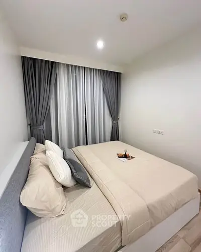 Cozy modern bedroom with elegant curtains and stylish bedding