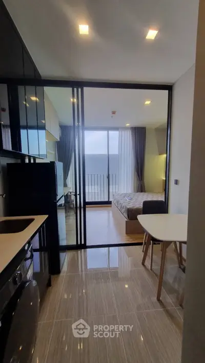 Modern studio apartment with open layout and balcony view