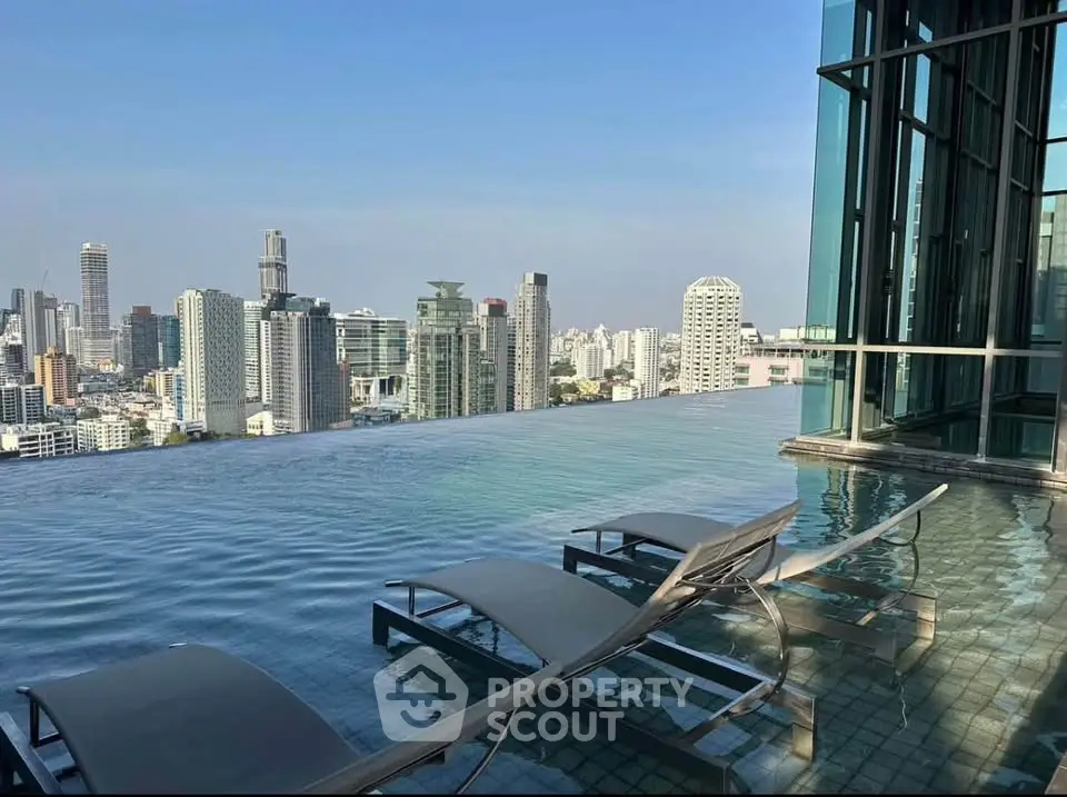 Luxurious rooftop infinity pool with stunning city skyline view, perfect for urban living enthusiasts.