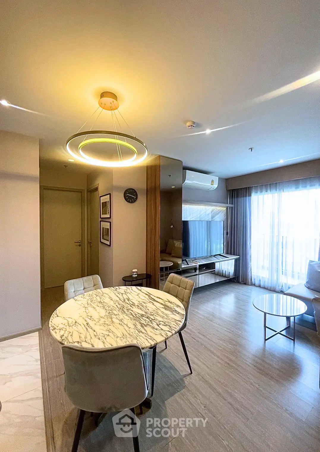 Modern living room with elegant dining area and stylish lighting in a contemporary apartment.