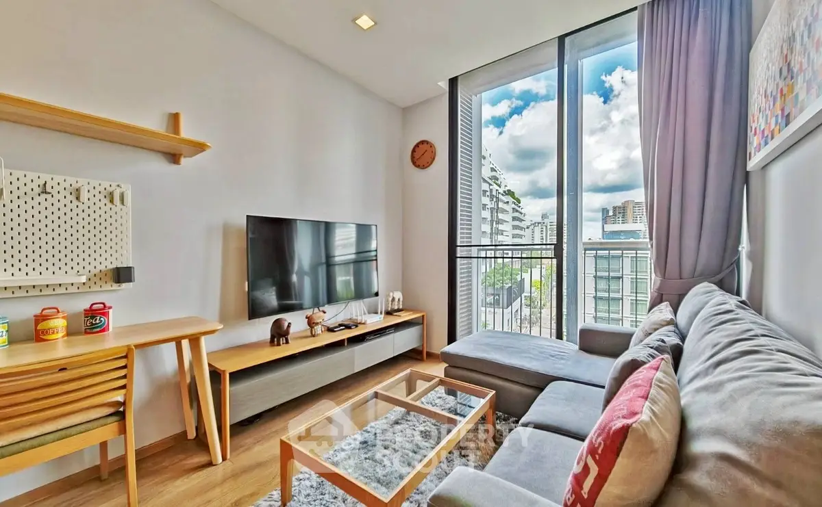 Modern living room with large window and stylish decor in urban apartment