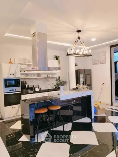 Luxurious modern kitchen with black marble island and stylish lighting