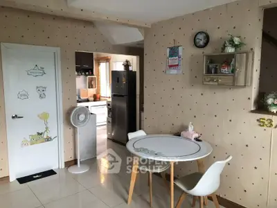 Charming kitchen with modern appliances and cozy dining area in a stylish home.